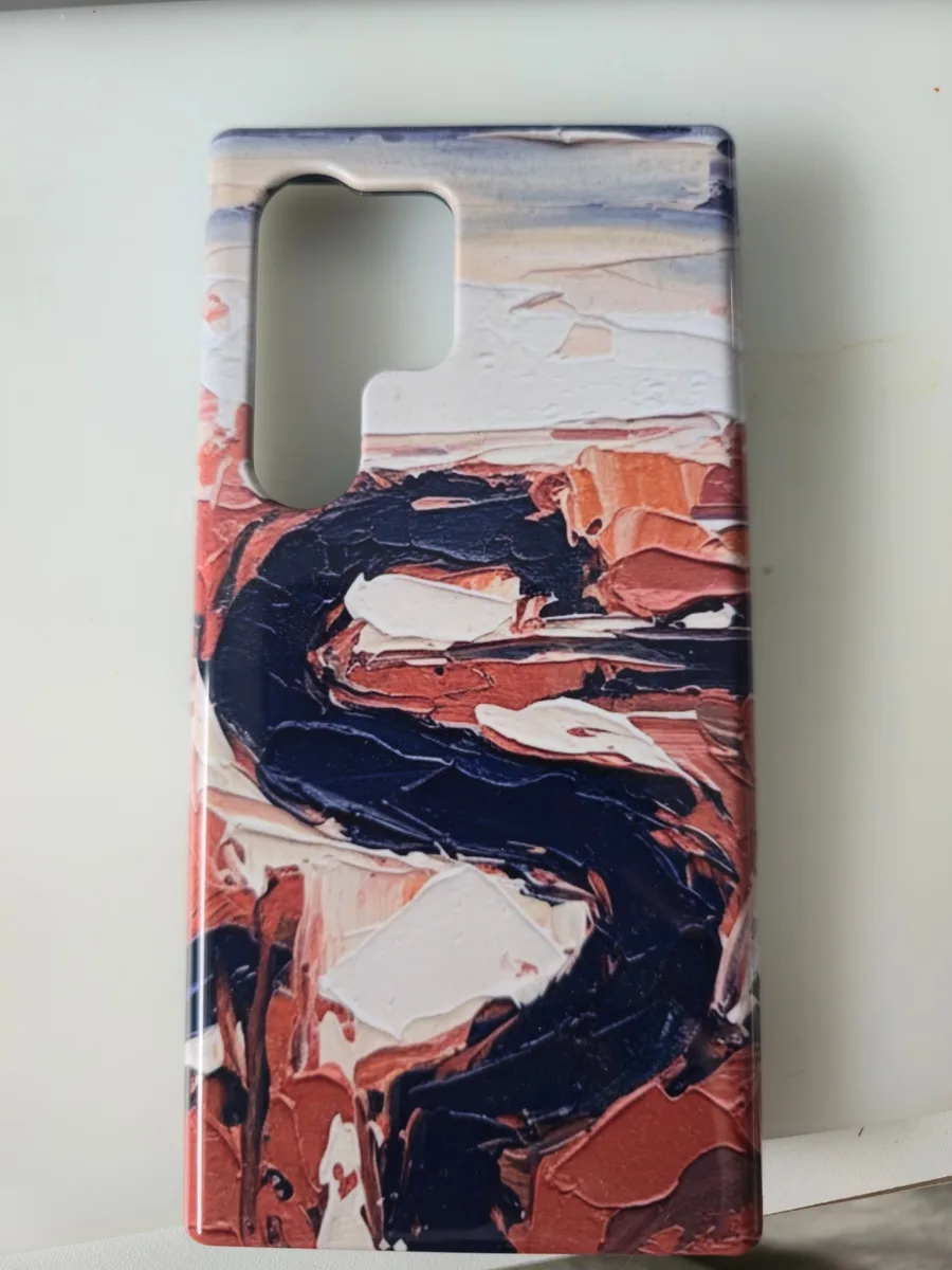 Delivered Aura Case for a Galaxy Ultra: textured oil-paint landscape in navy, rust and cream, glossy finish